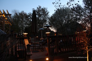 Low voltage deck lighting with lighted post caps and step lights.