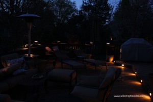 Low voltage deck lighting with lighted post caps and step lights.