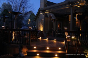 Low voltage deck lighting with lighted post caps and step lights.