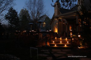 Low voltage deck lighting with lighted post caps and step lights.