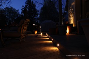 Low voltage deck lighting with lighted post caps and step lights.