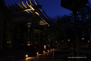 Low voltage deck lighting with lighted post caps and step lights.