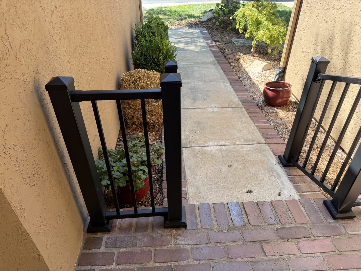 Handrails lining a walkway down to the front sidewalk