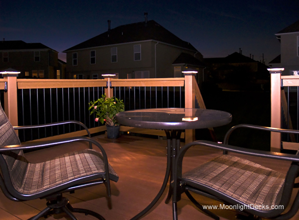 Low voltage deck lighting with lighted post caps.